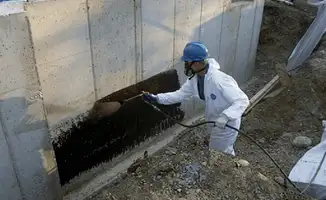 Professional waterproofing the exterior walls of the basement in Rochester, NY