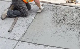 Professional repairing a concrete floor in Rochester, NY